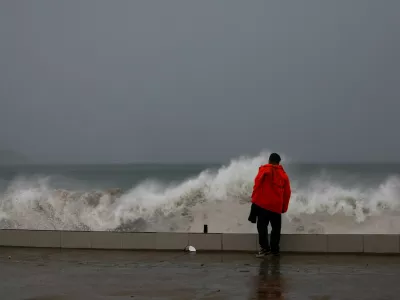 A person looks at waves hitting the waterfront as Hurricane Simon approaches Mexico's Pacific coast, bringing heavy rain and strong winds to Manzanillo, Mexico, October 11, 2026. REUTERS/Daniel Becerril