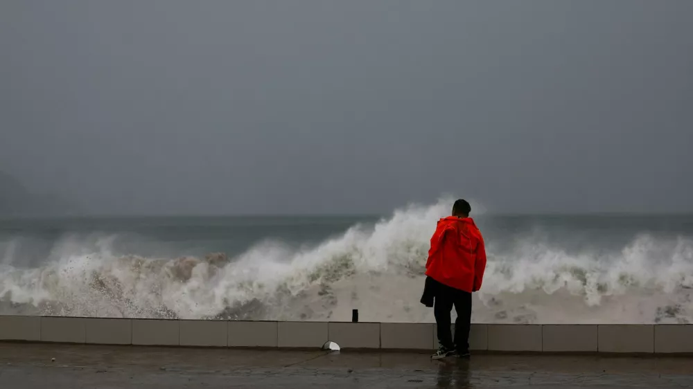 A person looks at waves hitting the waterfront as Hurricane Simon approaches Mexico's Pacific coast, bringing heavy rain and strong winds to Manzanillo, Mexico, October 11, 2026. REUTERS/Daniel Becerril