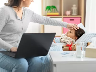 family, health and people concept - ill daughter and mother with laptop computer at home