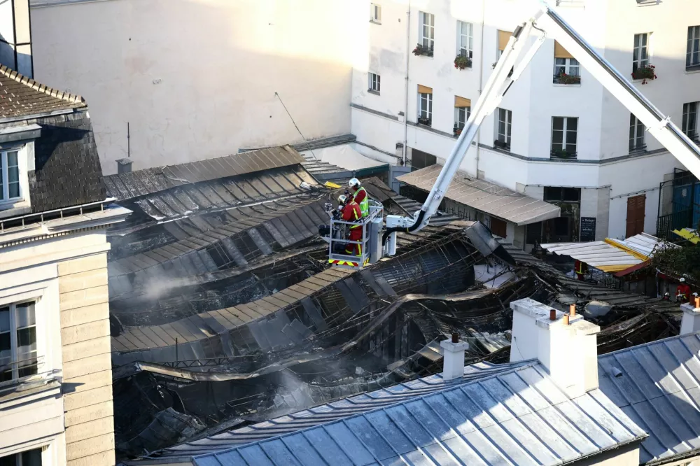 View of the destroyed roof of the Marche des Enfants Rouges market in central Paris as French firefighters conduct safety operations after the market was ravaged by a fire, in Paris, France, October 12, 2026. REUTERS/Sarah Meyssonnier   TPX IMAGES OF THE DAY