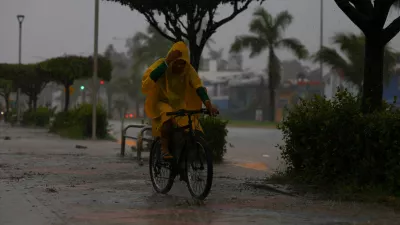 A man rides a bicycle as Hurricane Simon approaches Mexico's Pacific coast, bringing heavy rain and strong winds to Manzanillo, Mexico, October 11, 2026. REUTERS/Daniel Becerril