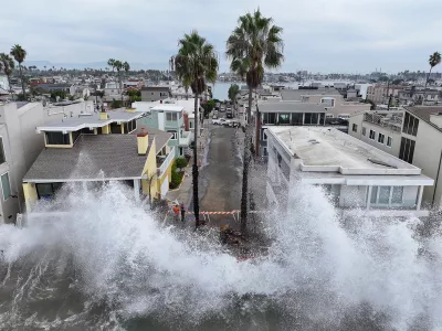Waves hit a walkway in front of homes in Long Beach, Calif., Saturday, Oct. 10, 2026, as Tropical Storm Rachel approaches. (AP Photo/William Liang)
