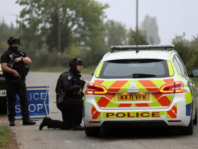 Police officers guard an area as roadblocks remain in place near RAF Fairford airbase, after police declared a major incident at the base and arrested several men on suspicion of offences under the Explosives Act, who have since been released on bail, in Fairford, Gloucestershire, Britain, September 29, 2026. REUTERS/Toby Shepheard   TPX IMAGES OF THE DAY