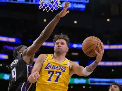 Oct 8, 2026; Los Angeles, California, USA; Los Angeles Lakers guard Luka Doncic (77) is defended by Sacramento Kings forward Precious Achiuwa (9) during the second half at Crypto.com Arena. Mandatory Credit: Jayne Kamin-Oncea-Imagn Images