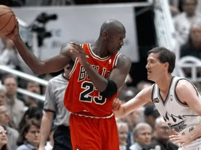 FILE - Chicago Bulls' Michael Jordan pulls the ball out of reach of Utah Jazz guard Jeff Hornacek during third quarter action in Game 2 of the NBA Finals in Salt Lake City, June 5, 1998. (AP Photo/Mark J. Terrill, file)