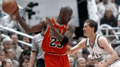 FILE - Chicago Bulls' Michael Jordan pulls the ball out of reach of Utah Jazz guard Jeff Hornacek during third quarter action in Game 2 of the NBA Finals in Salt Lake City, June 5, 1998. (AP Photo/Mark J. Terrill, file)