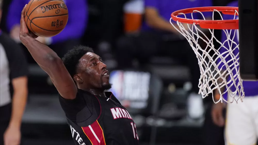 FILE - In this Oct. 11, 2020, file photo, Miami Heat's Bam Adebayo (13) dunks during the second half in Game 6 of basketball's NBA Finals against the Los Angeles Lakers in Lake Buena Vista, Fla. Adebayo and the Miami Heat are working on a contract extension, the team said Tuesday, Nov. 24, 2020, a deal that when finalized will likely guarantee him at least $168 million over the next six seasons and perhaps as much as $200 million in that span.(AP Photo/Mark J. Terrill, File)