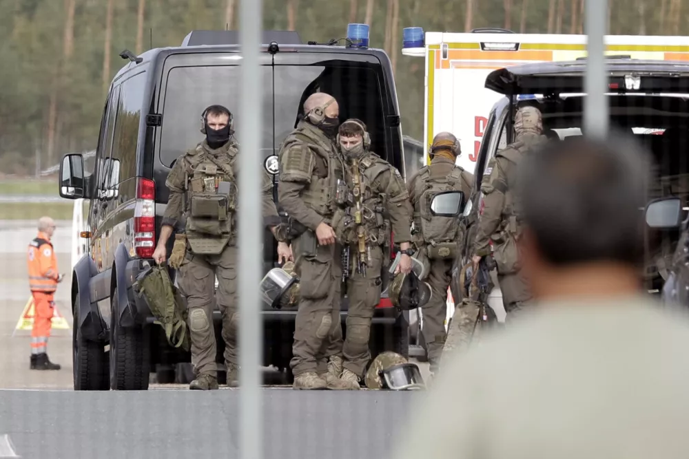 Members of a Police special operations unit (SEK) are on the move within the Nuremberg airport grounds in Nuremberg, Germany, Tuesday, Oct. 13, 2026. (Tizian Gerbing/dpa via AP)