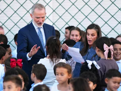 Spain's King Felipe VI and Queen Letizia speak with pupils at the Vicente Aleixandre public school during their visit to the Spanish enclave of Ceuta, Tuesday, Oct. 13, 2026. (AP Photo/Manu Fern&aacute;ndez)
