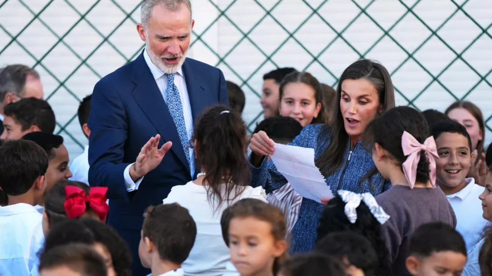 Spain's King Felipe VI and Queen Letizia speak with pupils at the Vicente Aleixandre public school during their visit to the Spanish enclave of Ceuta, Tuesday, Oct. 13, 2026. (AP Photo/Manu Fern&aacute;ndez)
