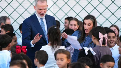 Spain's King Felipe VI and Queen Letizia speak with pupils at the Vicente Aleixandre public school during their visit to the Spanish enclave of Ceuta, Tuesday, Oct. 13, 2026. (AP Photo/Manu Fern&aacute;ndez)