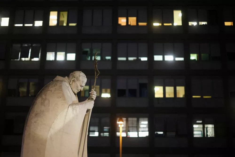 The statue of the late Pope John Paul II outside Gemelli Hospital, where Pope Leo is hospitalised ahead of surgery to remove a lung nodule, in Rome, Italy, October 13, 2026. REUTERS/Stoyan Nenov