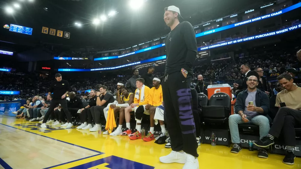 Los Angeles Lakers guard Luka Doncic stands in front of the bench during the first half of an NBA preseason basketball game against the Golden State Warriors, Tuesday, Oct. 6, 2026, in San Francisco. (AP Photo/Jeff Chiu)