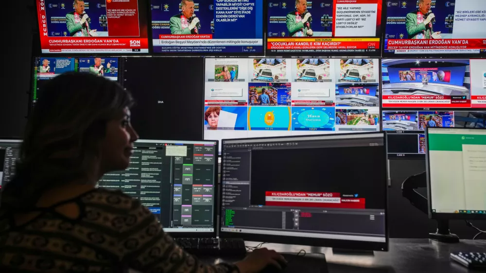 FILE -Screens at Turkish Halk TV news channel headquarters display Turkish President and People's Alliance's presidential candidate Recep Tayyip Erdogan, top, speaking during a rally, in Istanbul, Turkey, May 5, 2023. (AP Photo/Emrah Gurel, File)