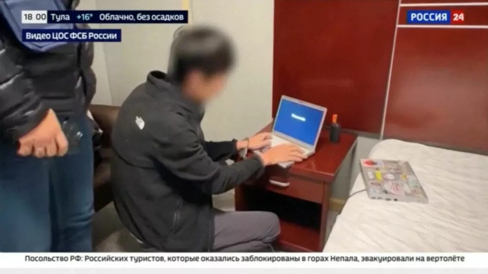 A view of the arrest of a person, identified by Russia's Federal Security Service (FSB) as a Japanese journalist for the Hokkaido Shimbun newspaper and accused of gathering information on Russia's defence capabilities, at an unidentified location, in this still image taken from a video aired by Rossiya-24 (RU24) state TV channel and released October 13, 2026. Rossiya-24/Handout via REUTERS ATTENTION EDITORS - THIS IMAGE HAS BEEN SUPPLIED BY A THIRD PARTY. NO RESALES. NO ARCHIVES. MANDATORY CREDIT. BLURRING AND OVERLAYS FROM SOURCE.