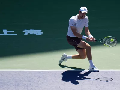 Botic van de Zandschulp, of the Netherlands, returns a ball to Rafael Jodar, of Spain, during the fourth round of the men's singles match at the Shanghai Masters tennis tournament in Shanghai, China, Wednesday, Oct. 14, 2026. (AP Photo/Andy Wong)