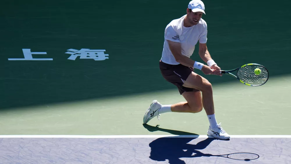 Botic van de Zandschulp, of the Netherlands, returns a ball to Rafael Jodar, of Spain, during the fourth round of the men's singles match at the Shanghai Masters tennis tournament in Shanghai, China, Wednesday, Oct. 14, 2026. (AP Photo/Andy Wong)