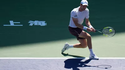 Botic van de Zandschulp, of the Netherlands, returns a ball to Rafael Jodar, of Spain, during the fourth round of the men's singles match at the Shanghai Masters tennis tournament in Shanghai, China, Wednesday, Oct. 14, 2026. (AP Photo/Andy Wong)