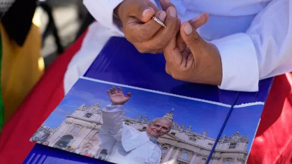 A nun holds a picture of Pope Leo XIV as she prays prior to the start of a Mass to conclude the Vatican meeting of the heads of Eastern Catholic Churches and presidents of bishops' conferences titled "Ten Years After Amoris Laetitia: Proclaiming the Gospel With Families Today," in St. Peter's Square, at the Vatican, Wednesday, Oct. 14, 2026. (AP Photo/Gregorio Borgia)