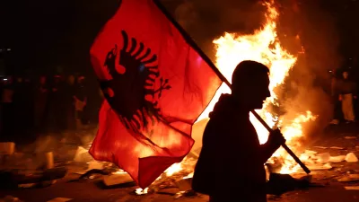 A protester holds an Albanian national flag as Albanian students hold an anti-government protest in Tirana, Albania, October 13, 2026. REUTERS/Florion Goga