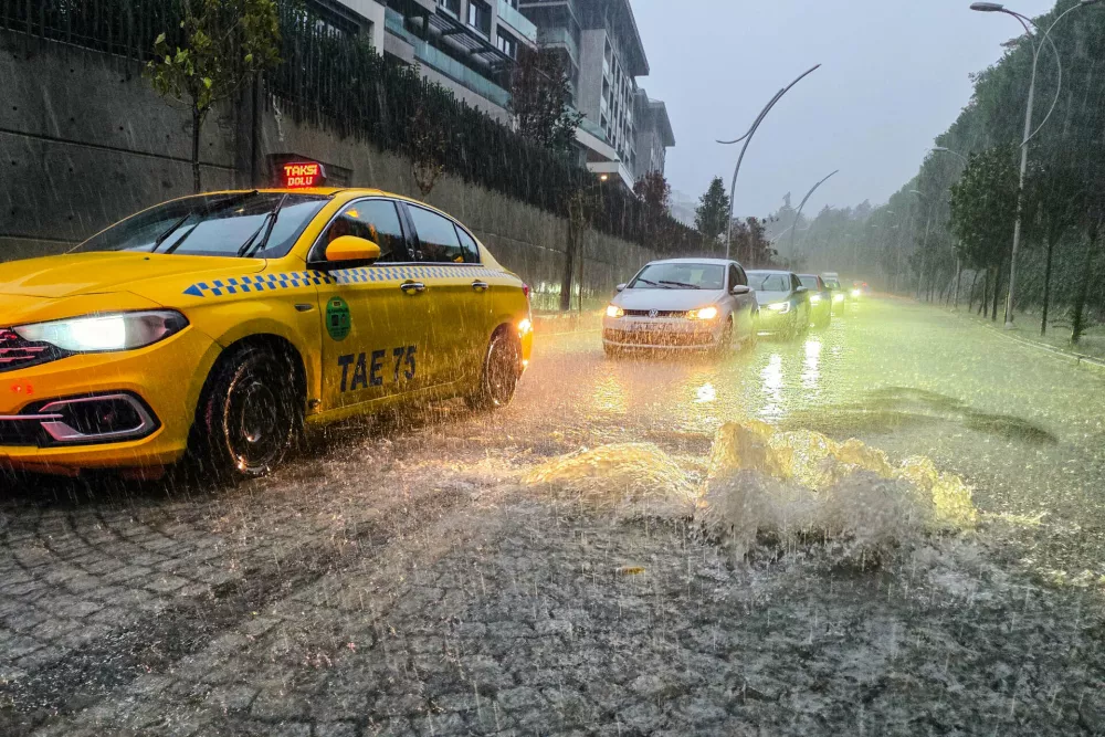 Vehicles drive along a partially flooded road during a heavy rain in Istanbul, Turkey, Wednesday, Oct. 14, 2026. (Omer Hamza Yildiz/DIA Photo via AP)