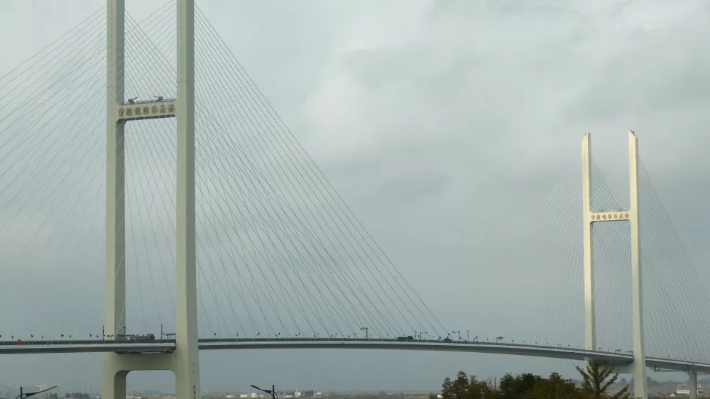 Trucks cross the newly opened New Yalu River Bridge, which connects China's Dandong New Zone and North Korea's Sinuiju, as seen from Dandong, Liaoning Province, China, October 15, 2026. REUTERS/Florence Lo