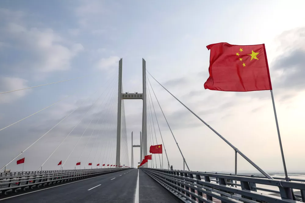 In this photo released by Xinhua News Agency, Chinese flags are flown during the opening ceremony of the new China-North Korea Yalu River Bridge at the border between the two countries on Thursday, Oct. 15, 2026. (Pan Yulong/Xinhua via AP)