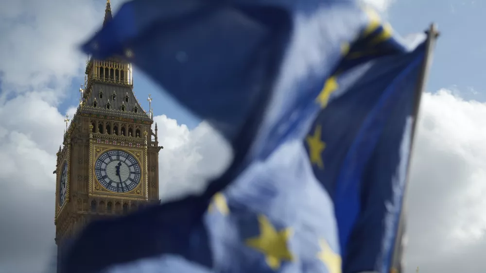 Pro EU supporters wave EU flags outside The Houses of Parliament in London, Wednesday, Oct. 14, 2026. (AP Photo/Alastair Grant)
