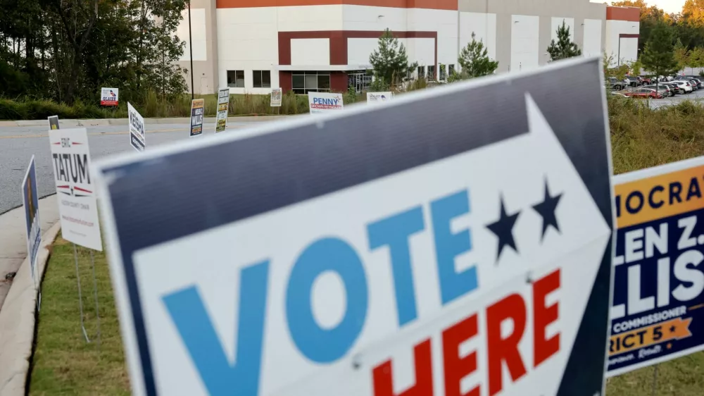 Early midterm voting is advertised at a polling place in the Fulton County Election Hub and Operation Center, the site searched by the FBI and then-Director of National Intelligence Tulsi Gabbard in January, in Union City, Georgia, US, October 13, 2026. REUTERS/Jonathan Ernst 