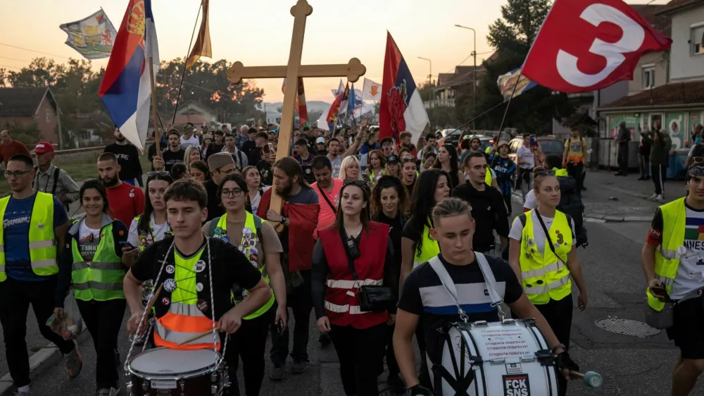 Students from Gornji Milanovac walk along a road with flags and drums during their walk to Belgrade in the town of Lajkovac, Serbia, October 19, 2026. REUTERS/Marko Djurica