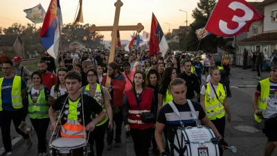 Students from Gornji Milanovac walk along a road with flags and drums during their walk to Belgrade in the town of Lajkovac, Serbia, October 19, 2026. REUTERS/Marko Djurica