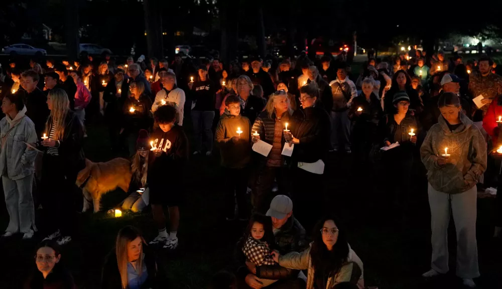 People gather for a candlelight vigil held in Drake Park in Bend, Ore., Thursday, Oct. 15, 2026, following a shooting at Silver Rail Elementary School earlier in the day. (Eli Imadali/Oregon Public Broadcasting via AP)