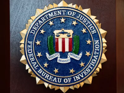 FILE - An FBI seal is displayed on a podium before a news conference at the field office in Portland, Ore., Jan. 16, 2025. (AP Photo/Jenny Kane, File)
