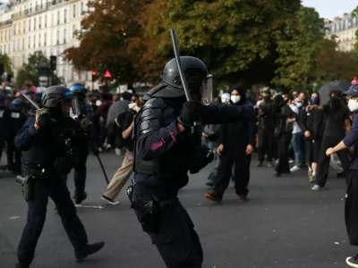 French CRS riot police raise batons towards protesters amid clashes at the Place de la Nation during a demonstration by high school and university students, supported by teachers' union and school parents, in Paris as part of a nationwide day of protests and blockades, voicing anger over overcrowded classrooms, teacher shortages and dilapidated school buildings, which students blame on years of underinvestment, France, October 6, 2026. REUTERS/Abdul Saboor