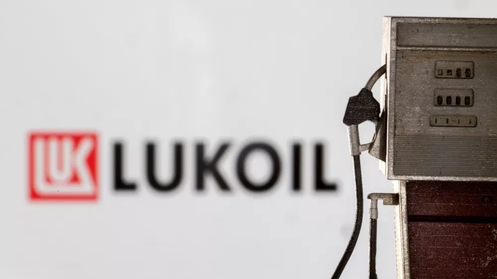 Model of petrol pump is seen in front of LUKOIL logo in this illustration taken March 25, 2022. REUTERS/Dado Ruvic/Illustration