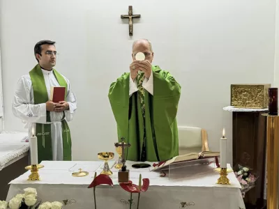 This picture released by Vatican Media on Friday, Oct. 16, 2026, shows Pope Leo XIV, flanked by his personal secretary monsignor Edgard Iv&aacute;n Rimaycuna Inga, left, celebrating Mass at the Agostino Gemelli Polyclinic in Rome where he's recovering after he had a cancer removed from his right lung. (Vatican Media via AP)