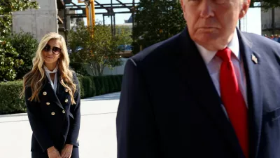 FILE PHOTO: New White House Press Secretary Katie Zacharia stands behind US President Donald Trump as he departs the White House in Washington, DC, US, October 13, 2026.  REUTERS/Kevin Lamarque/File Photo