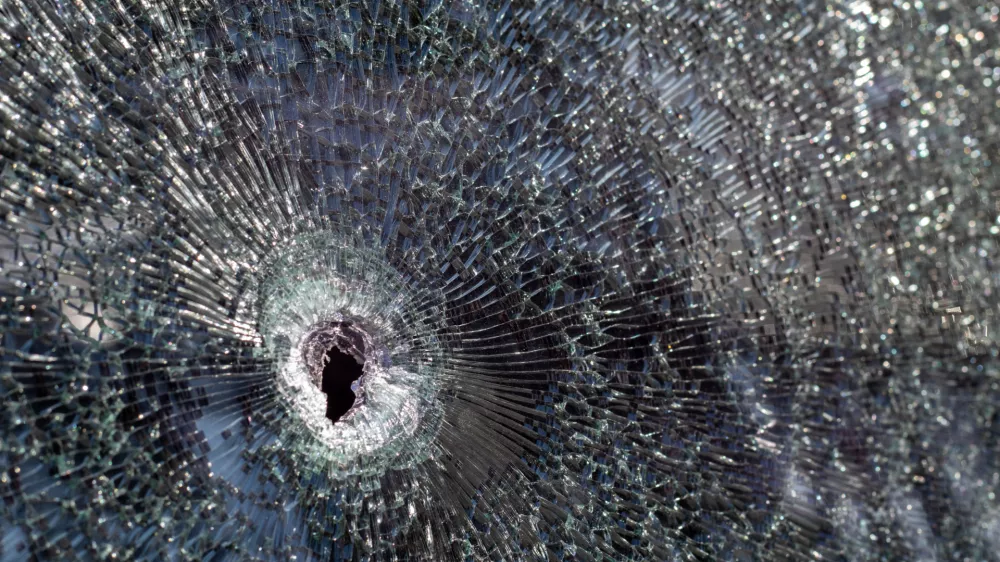Holes on the windshield of the car, it was shot from a firearm. Bullet holes. Smash car windshield, broken and damaged car. The bullet made a cracked hole in the glass / Foto: Yevhen Roshchyn