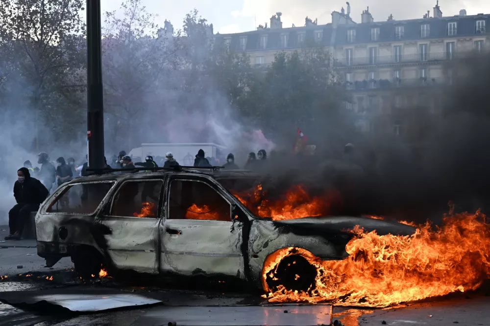 A car burns at Place de La Republique during a protest against rising living costs in Paris, Saturday, Oct. 17, 2026. (AP Photo/Emma Da Silva)