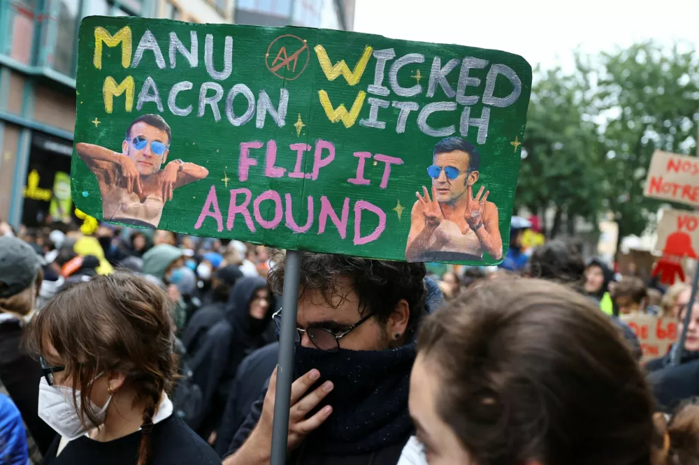 A demonstrator holds a placard as people take part in a demonstration as part of nationwide protests called by the "Yellow Vests" movement against the cost of living and rising fuel prices, Strasbourg, France, October 17, 2026. REUTERS/Kai Pfaffenbach