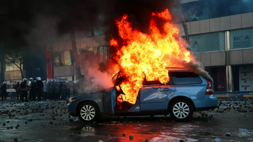 A car burns during an anti-government protest by students in Tirana, Albania, October 17, 2026. REUTERS/Florion Goga