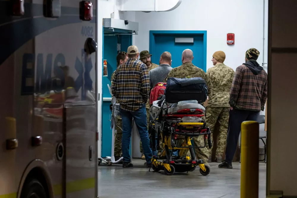 Emergency crews and military personnel are seen at the Wainwright Health Centre as injured military members are treated after a fire at Canadian Forces Base Wainwright, outside of Wainwright, Alberta Saturday, Oct. 17, 2026. (John Ulan/The Canadian Press via AP)