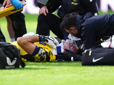 Chelsea goalkeeper Emiliano Martinez receives treatment for an injury during the English Premier League soccer match between Everton and Chelsea in Liverpool, England, Saturday, Oct. 17, 2026. (Mike Egerton/PA via AP)
