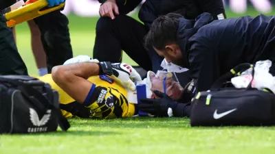 Chelsea goalkeeper Emiliano Martinez receives treatment for an injury during the English Premier League soccer match between Everton and Chelsea in Liverpool, England, Saturday, Oct. 17, 2026. (Mike Egerton/PA via AP)