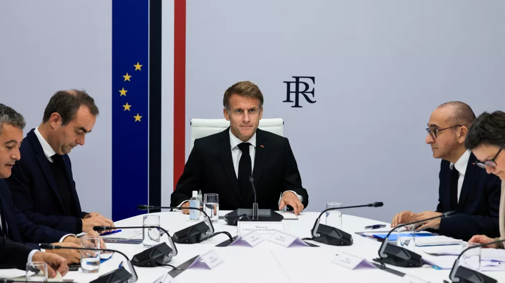 France's President Emmanuel Macron, center, hosts an Interministerial Crisis Meeting at the Elysee Presidential Palace, in Paris, on Sunday, Oct. 18, 2026 the day after nationwide riots. (Ludovic Marin/Pool Photo via AP)
