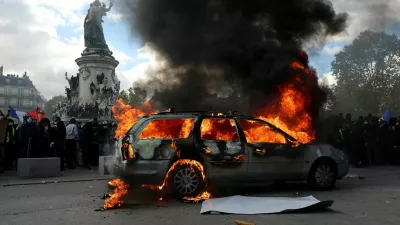A car burns amid clashes between protesters and the French police during a demonstration against the cost of living and rising fuel prices at the Place de la Republique in Paris as part of nationwide protests called by the "Yellow Vests" movement, joined by French high school and university students, teachers and parents demanding better school conditions and government action, as well as labour unions, workers, farmers and retirees, France, October 17, 2026. REUTERS/Stephanie Lecocq    TPX IMAGES OF THE DAY