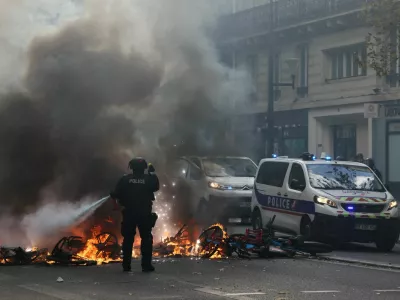 FILE PHOTO: A French police officer extinguish burning bicycles during a demonstration against the cost of living and rising fuel prices in Paris as part of nationwide protests called by the "Yellow Vests" movement, joined by French high school and university students, teachers and parents demanding better school conditions and government action, as well as labour unions, workers, farmers and retirees, France, October 17, 2026.  REUTERS/Jack Taylor/File Photo