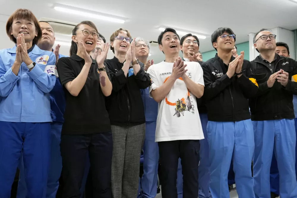 Employees of Japan Aerospace Exploration Agency and others celebrate as a Japanese spacecraft launched aboard an H3 rocket successfully separated as planned, at the Tanegashima Space Center in Kagoshima prefecture, southern Japan, Tuesday Oct. 20, 2026. (Naoki Hiraoka/Kyodo News via AP)