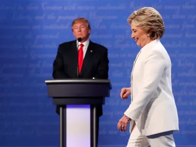 FILE PHOTO: Democratic U.S. presidential nominee Hillary Clinton walks off the debate stage as Republican U.S. presidential nominee Donald Trump remains at his podium after the conclusion of their third and final 2016 presidential campaign debate at UNLV in Las Vegas, Nevada, U.S., October 19, 2016. REUTERS/Rick Wilking/File Photo