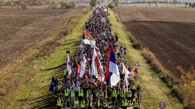An aerial view of students marching through the fields in northern Serbia, as they go to Novi Sad for a huge rally on Nov. 1 marking the first anniversary of a train station disaster that killed 16 people, in Indjija, Serbia, Friday, Oct. 31, 2025. (AP Photo/Armin Durgut)